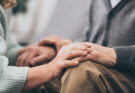Cropped view of retired couple holding hands